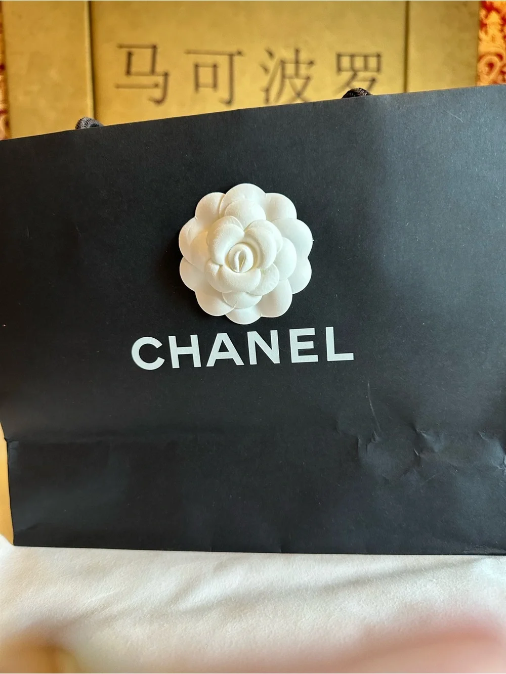 CHANEL White Camellia Hair Accessory and shopping bag